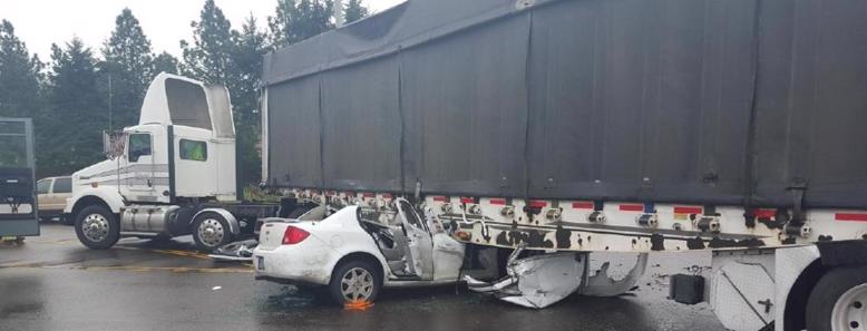 a car lodged under the trailer of a semi truck in richmond, va