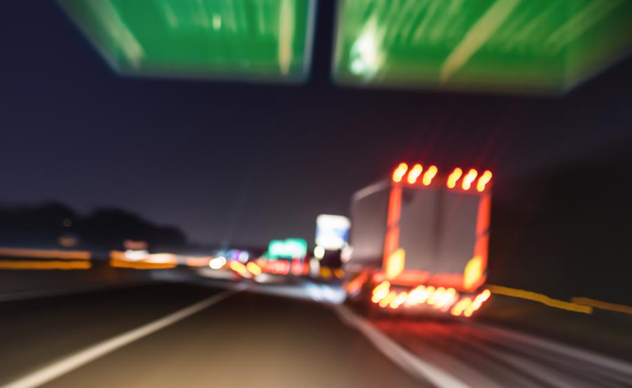 a truck speeding down the interstate at night.